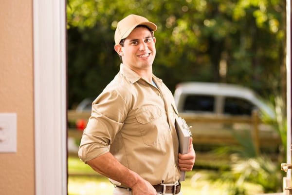 Pest-control-professional-at-a-residential-front-door