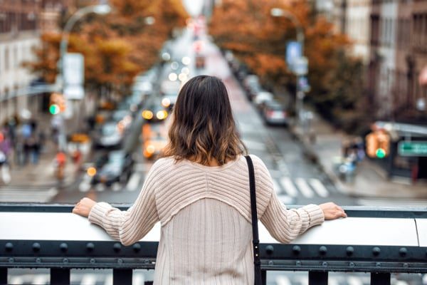 woman looking over city street