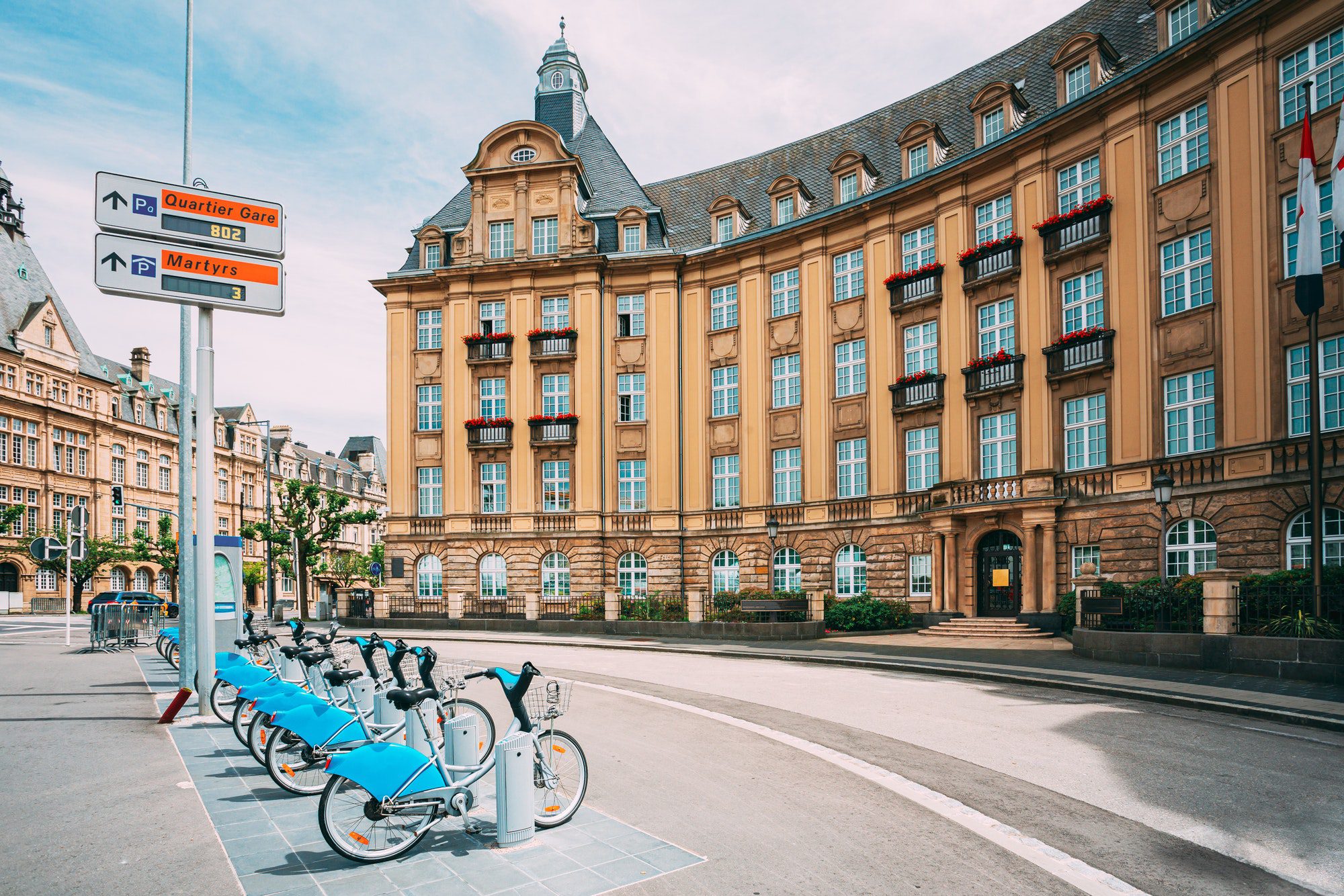 LUXEMBOURG. Row of city bikes for rent on a background of bank building