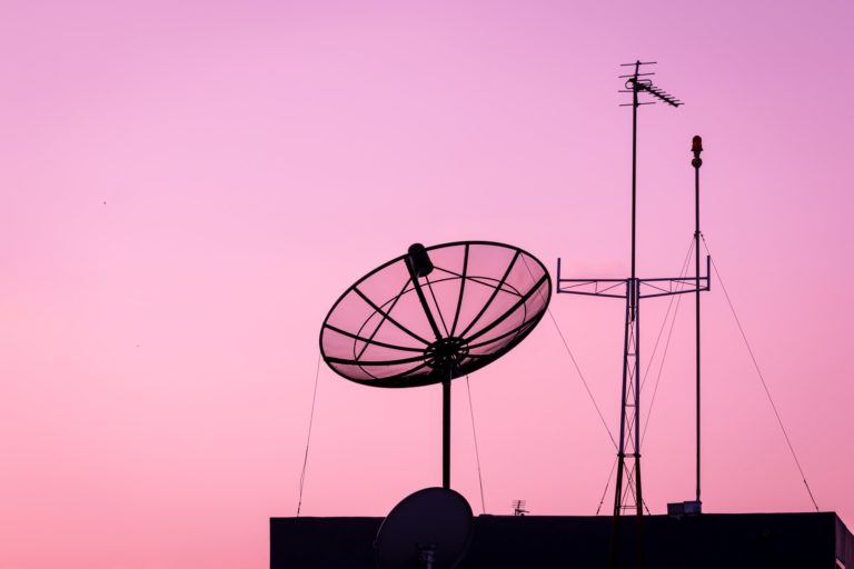Silhouette of a Satellite dish and Television or telecommunication antenna with sky sunset twilight